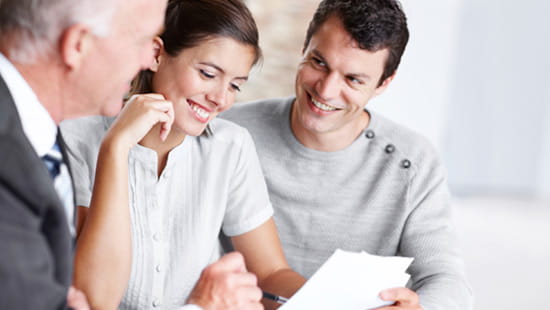 Advisor giving financial advice to young couple